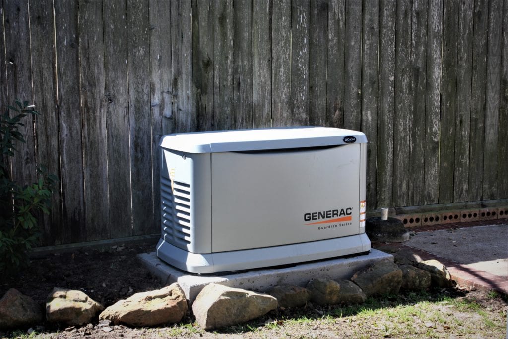 A licensed electrician meticulously installs a generator system with an automatic transfer switch that runs on natural gas